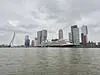 Netherlands, South Holland, Rotterdam (2025): Kop van Zuid with the MS Rotterdam of the Holland America Line and the Erasmus Bridge, seen from a Watertaxi on the Nieuwe Maas