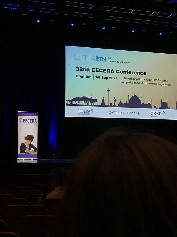 A presentation screen which reads 32nd EECERA Conference Brighton