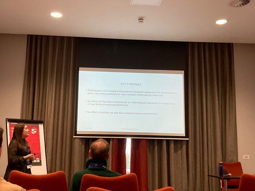 Isabelle is seen looking towards her slide summarising the key findings of her research.