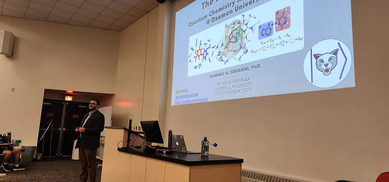 Dr. Dom and his title slide, which reads "The Kets are Wild: Quantum Chemistry in the Sirianni Lab @ Daemen University."