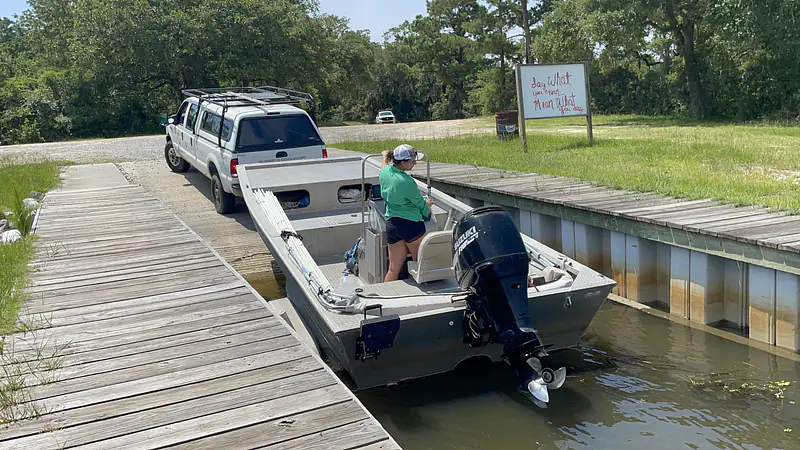 Driving a boat for field work along the Pearl River (MS)