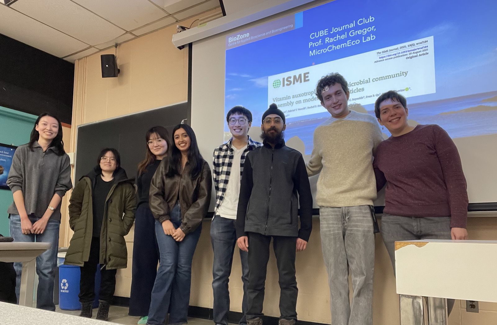 Group photo of 8 people in classroom
