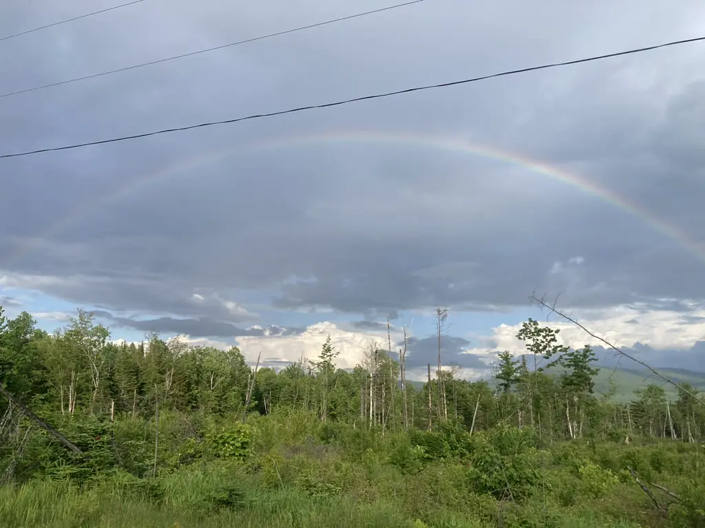 A break from rain in the field with a rainbow over Abenaki Land of the Wabanaki Nations, People of the First Light.