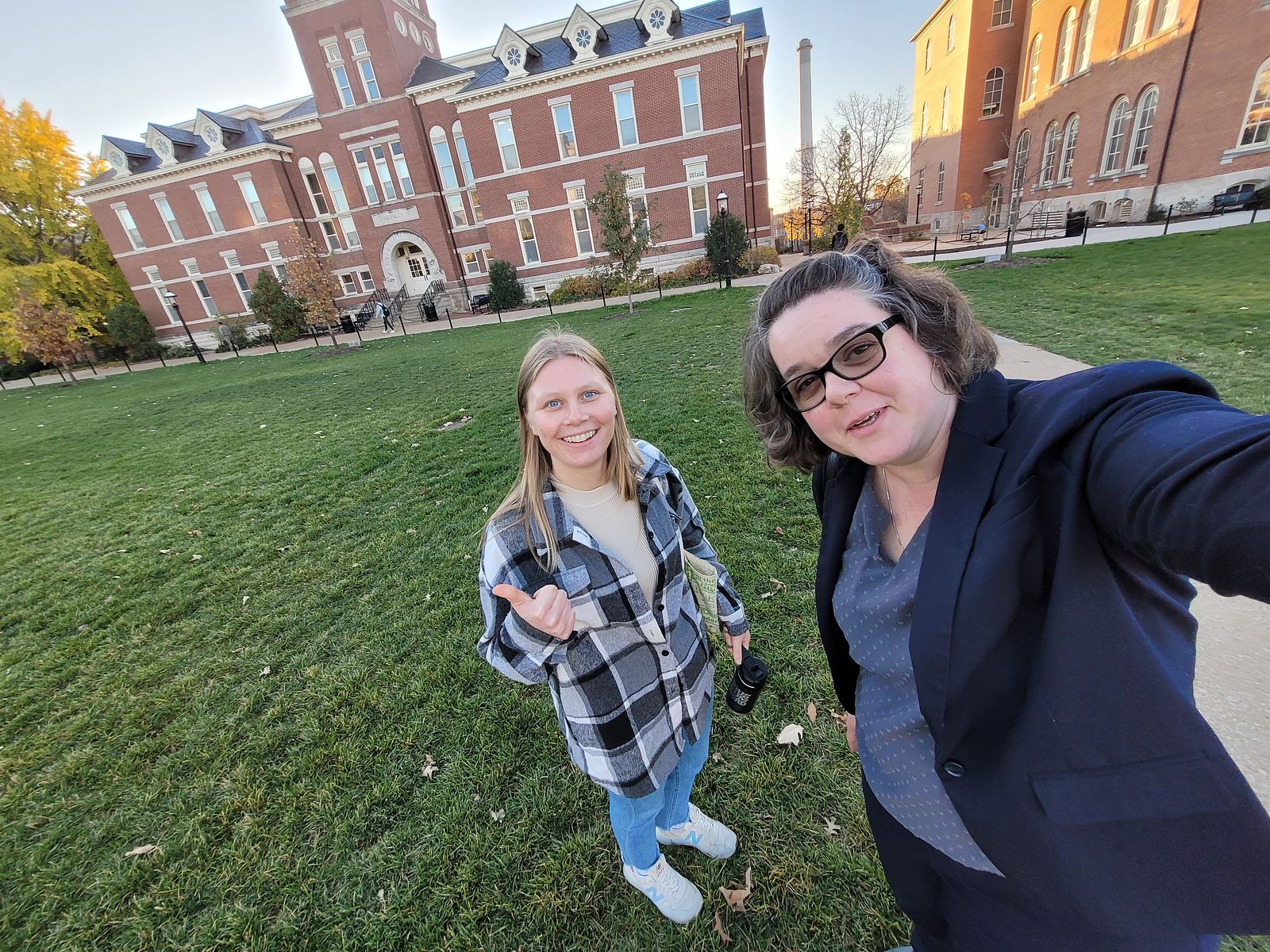 Two women standing in front of a brick building on a university campus in Missouri