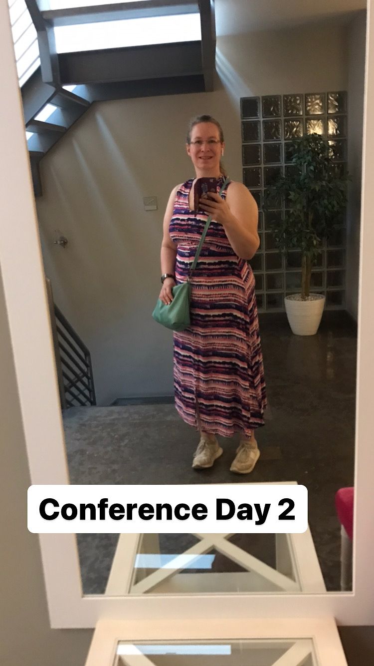 Selfie of a lady wearing a colourful stripey dress .