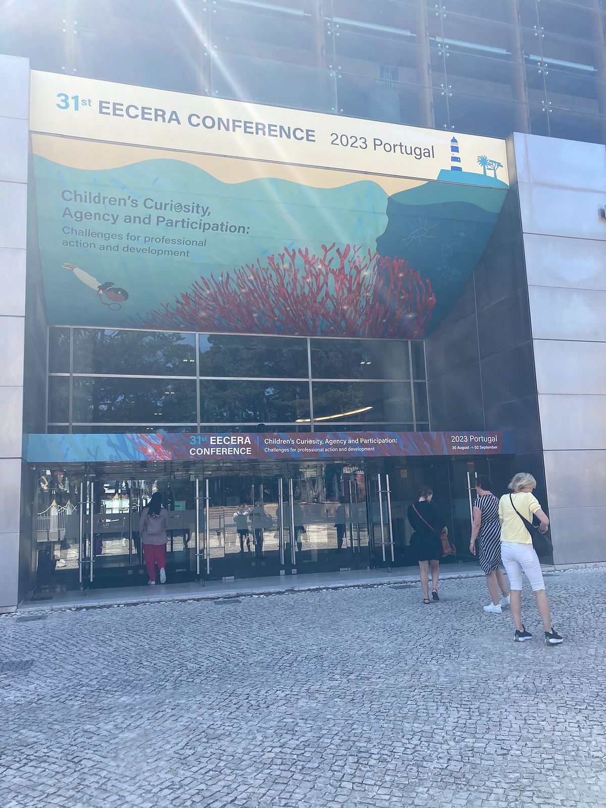The main entrance to the conference centre with the conference underwater logo above the doors.