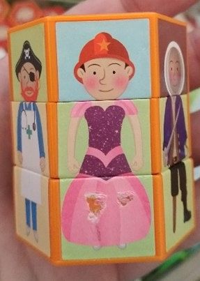 Hexagonal twisting toy with images of people wearing different clothes so you can twist the parts to create funny people.