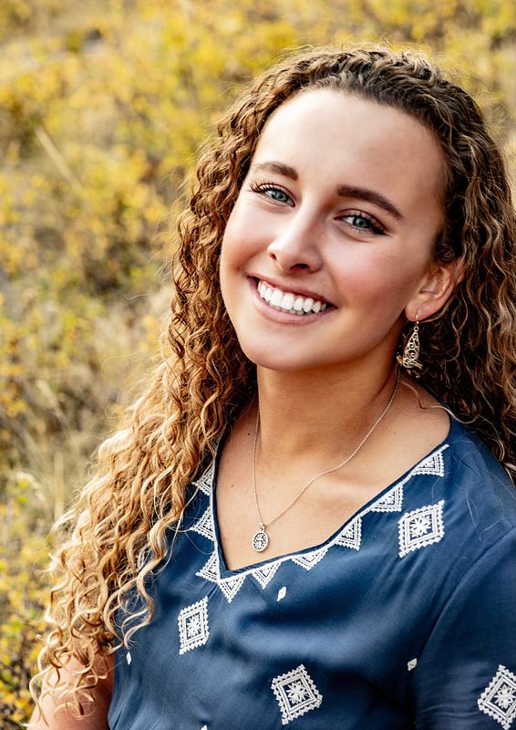 An image of Ashlyn Hansen with foliage in the background.