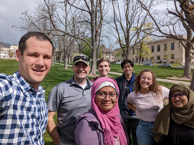 Jason, Josh, Sinthia, John, Jens, Ashlyn, and Tamanna posing for a group picture on the University of Utah campus