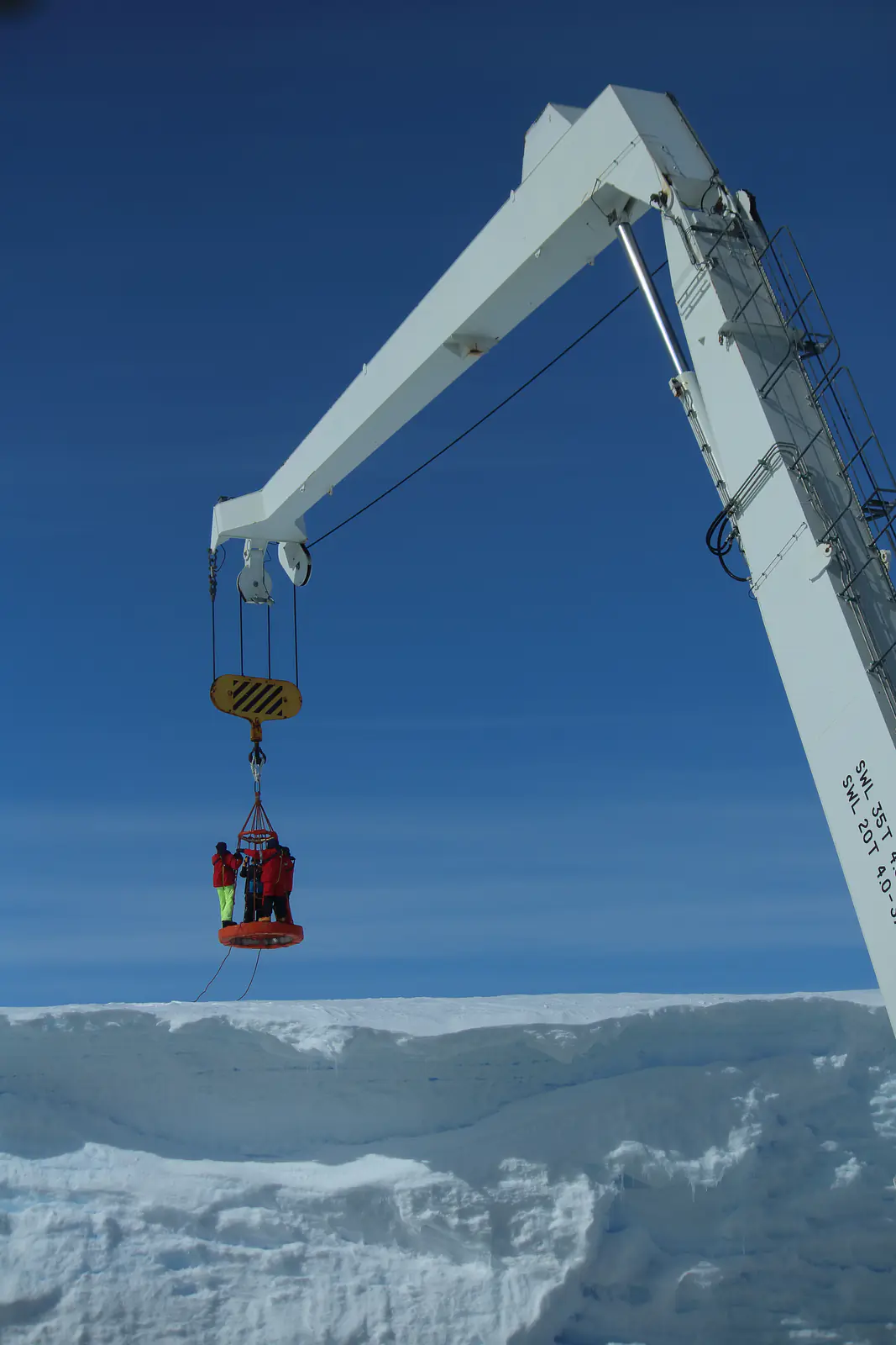 Basket & crane used to lower crew & scientist onto the ice shelf. Credit: Hannes Swart
