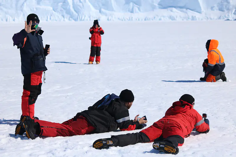 Me & others on bay ice watching penguins from afar. Credit: Hannes Swart