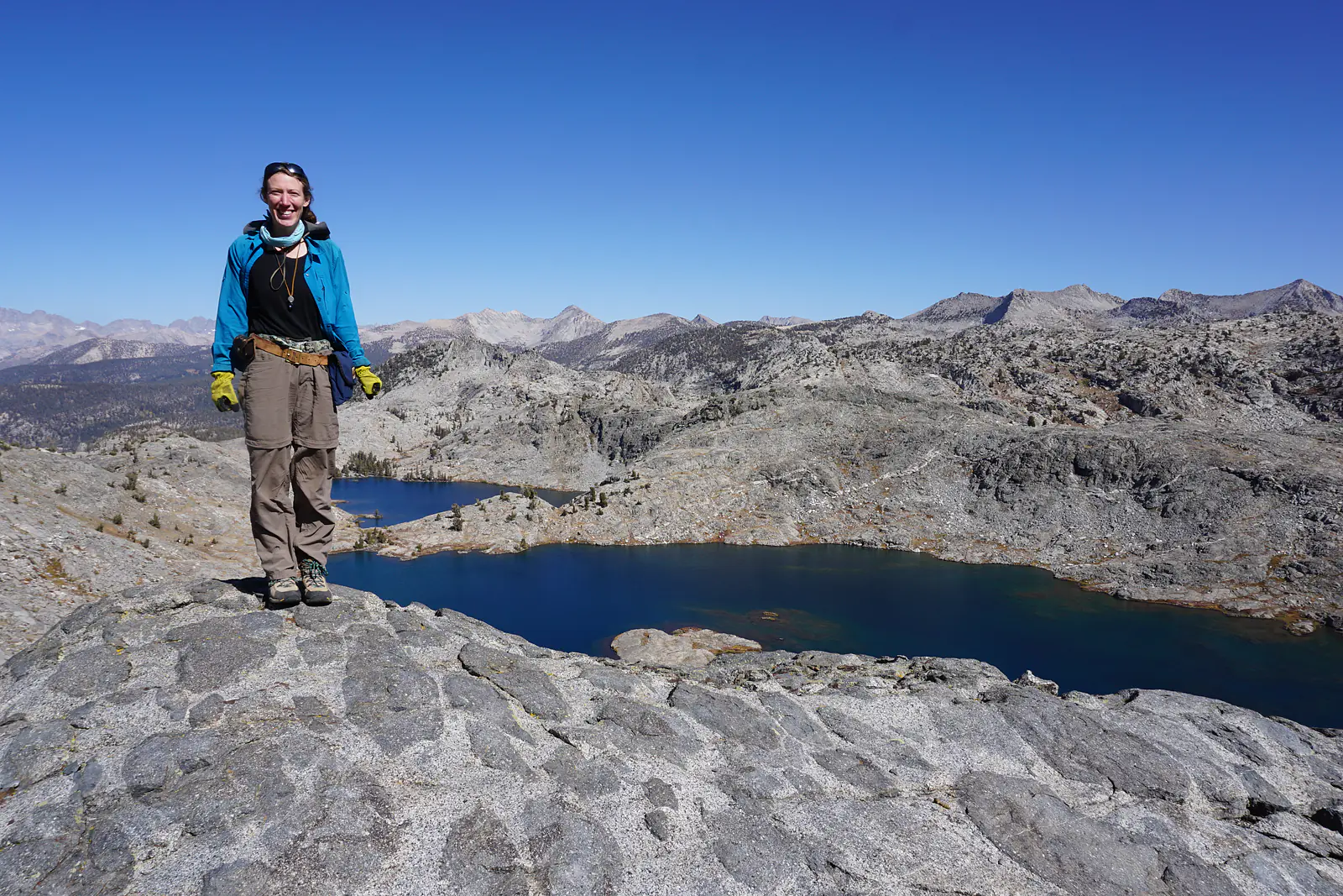 Juliet atop a special outcrop of mafic enclaves in Kings Canyon National Park—with more gabbro in view at Volcanic Lakes!!