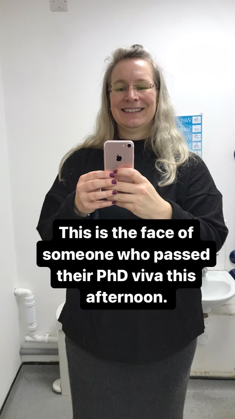 Very happy looking woman taking a  photo of themselves in a mirror