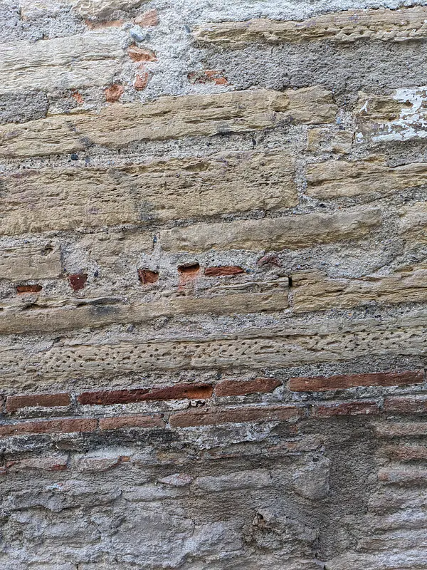 (Stratification of Moorish carved stone that was dismantled and reused by Catholics during the reconquista to build walls.)