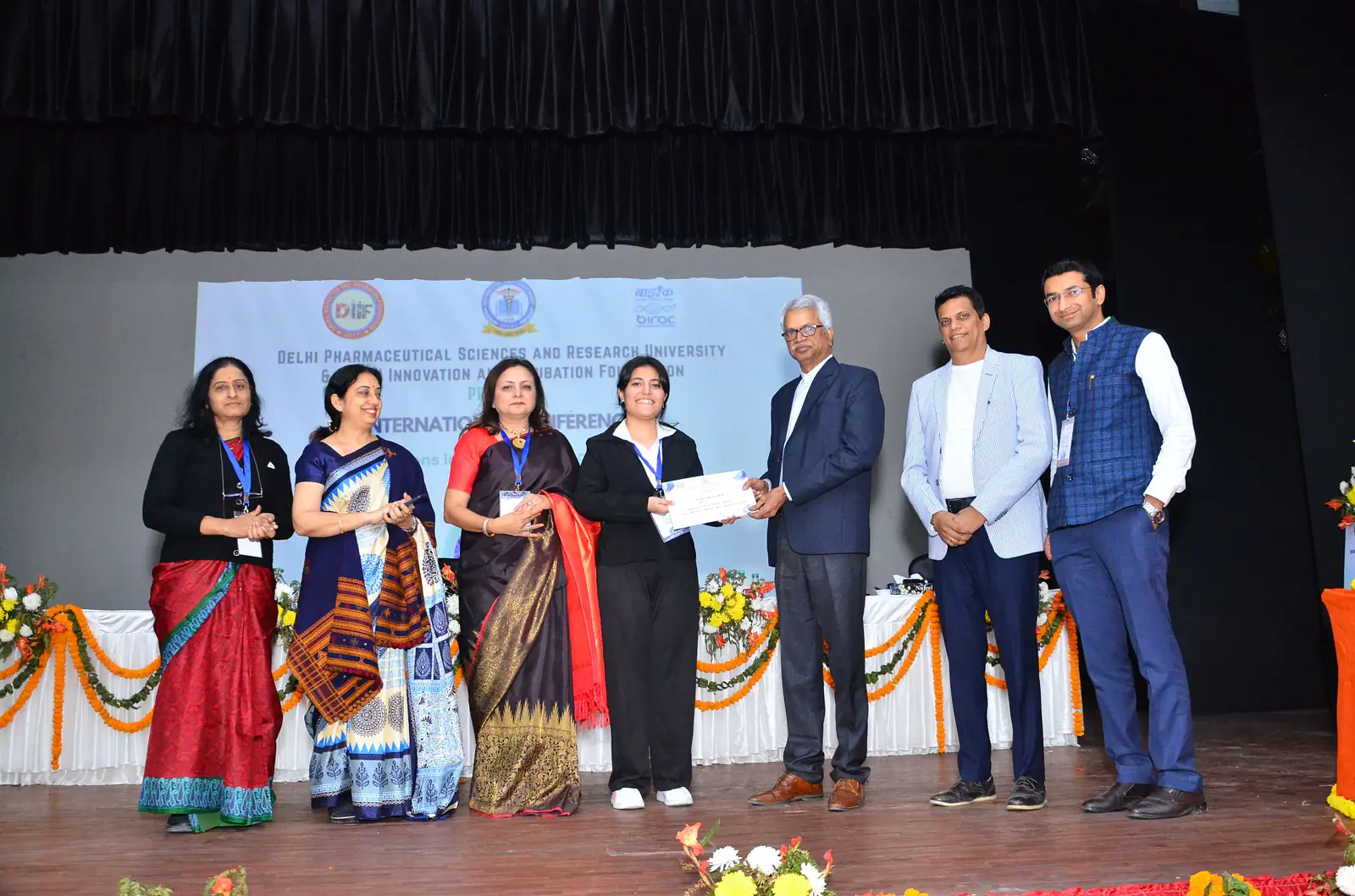 B. Pharm Student Rishika Receiving 1 Prize at ICIDAR 2024 
