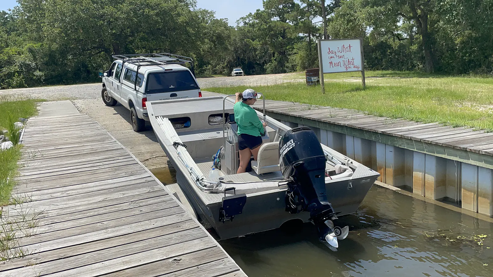 Driving a boat for field work along the Pearl River (MS)