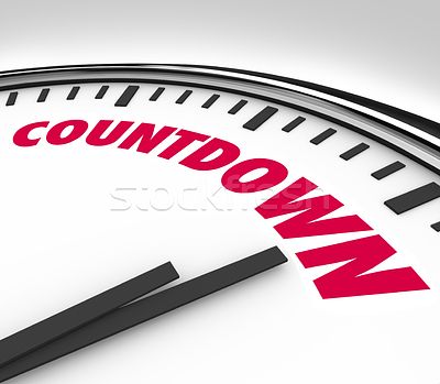 A close up image of a clock showing 15 minutes with both hands close together and the word countdown.